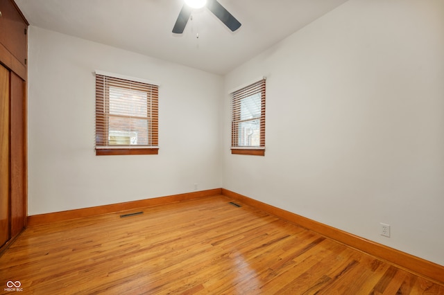 unfurnished bedroom with ceiling fan and light wood-type flooring