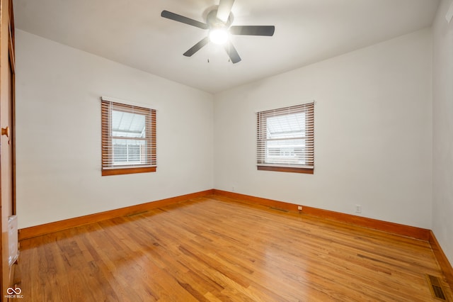 unfurnished room with light wood-type flooring, ceiling fan, and a healthy amount of sunlight