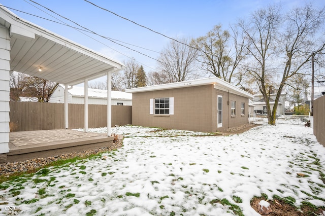 view of snow covered exterior featuring an outdoor structure