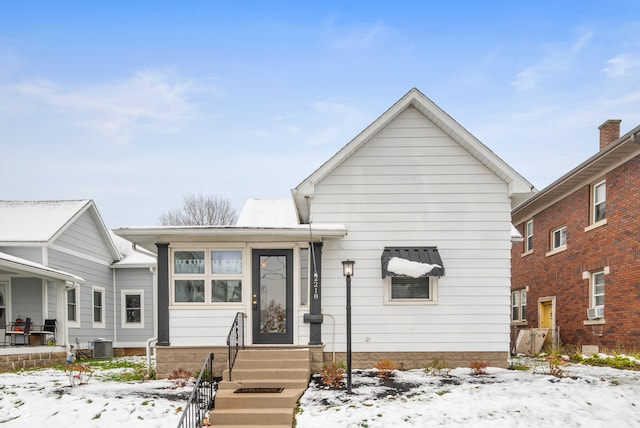 view of front of house with central AC unit and cooling unit