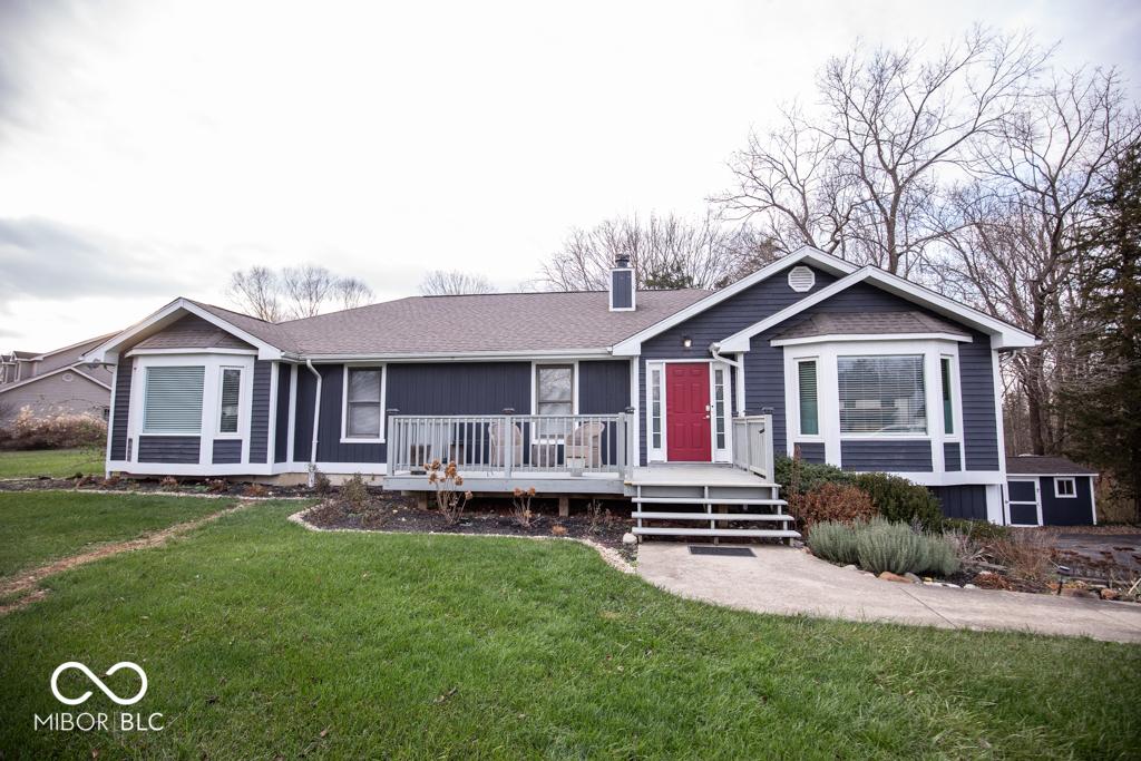 view of front facade with a front yard and a deck