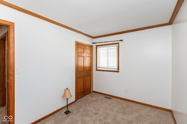 carpeted spare room with ornamental molding