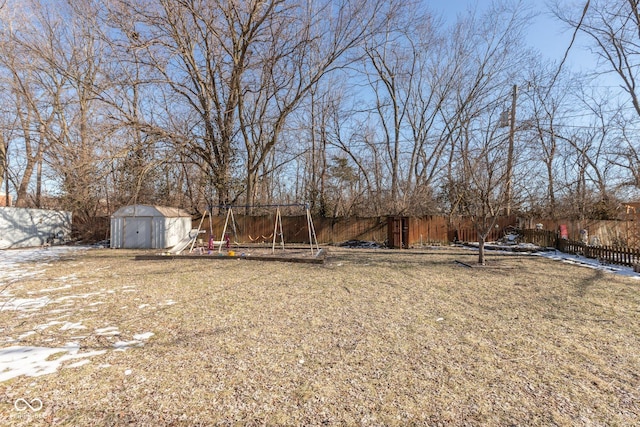 view of yard with a playground and a shed