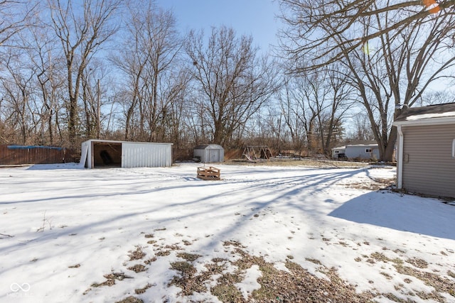 snowy yard with a trampoline and a storage shed