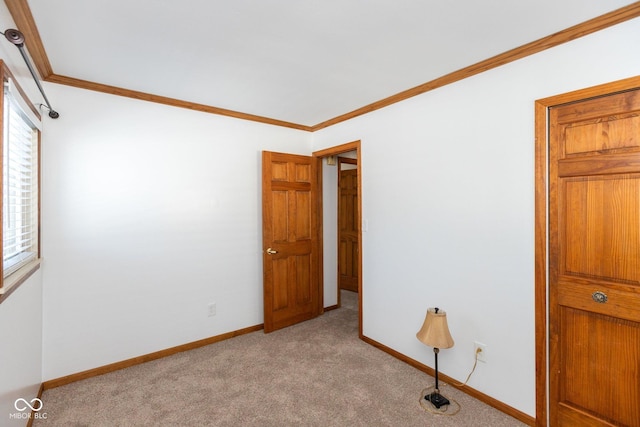 interior space featuring ornamental molding and light colored carpet