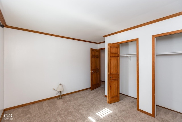 unfurnished bedroom with crown molding and light colored carpet