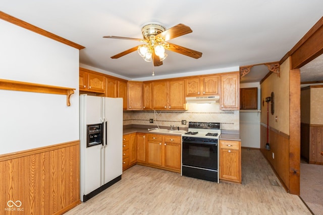 kitchen featuring tasteful backsplash, sink, white fridge with ice dispenser, range, and light hardwood / wood-style flooring