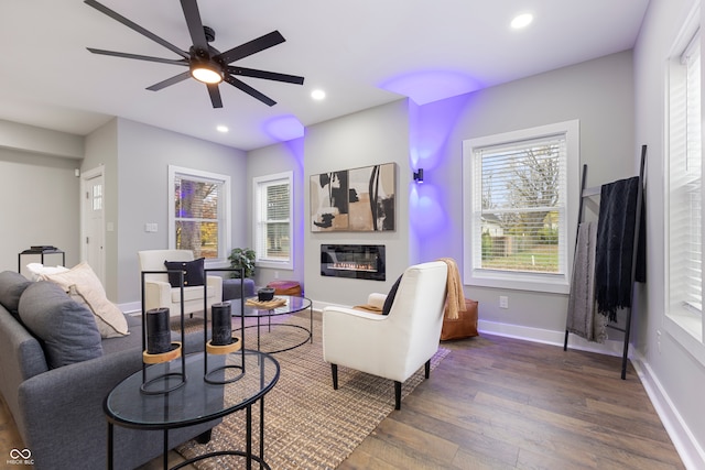 living room with dark hardwood / wood-style floors and ceiling fan