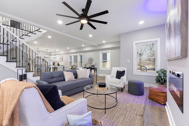 living room featuring hardwood / wood-style floors and ceiling fan