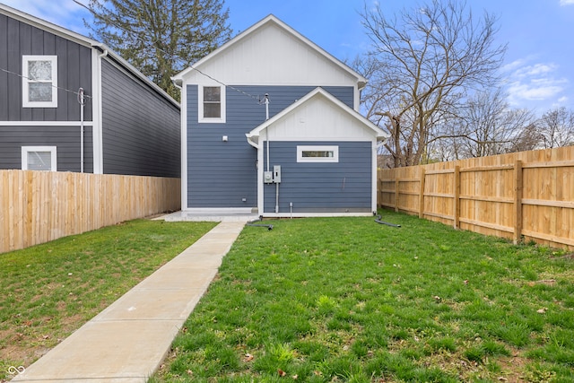 rear view of house with a yard