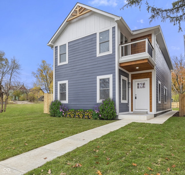 view of front of property with a balcony and a front yard