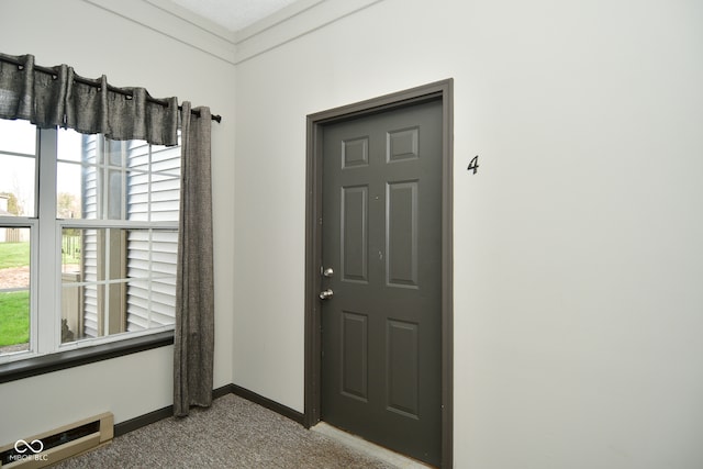 carpeted entryway featuring a wealth of natural light and a textured ceiling