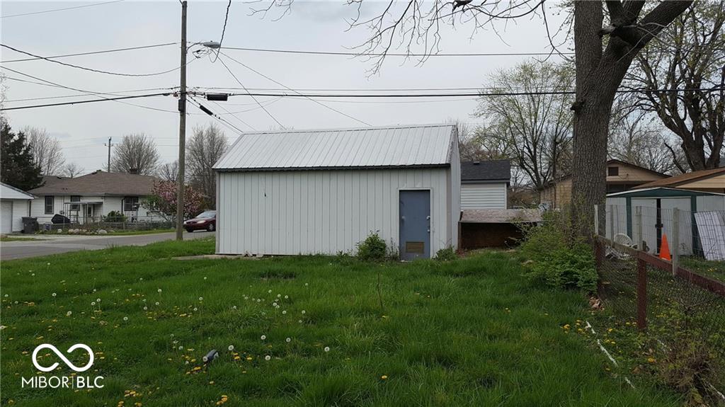 view of outdoor structure with a lawn