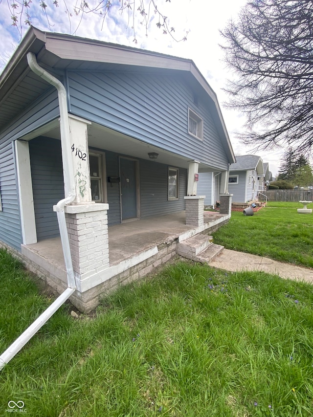 exterior space featuring a lawn and a porch