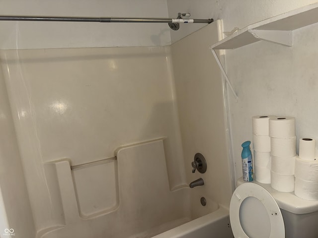 bathroom featuring toilet and shower / bathtub combination