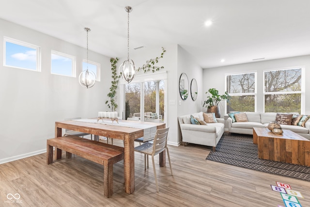 dining area featuring a chandelier and light hardwood / wood-style floors