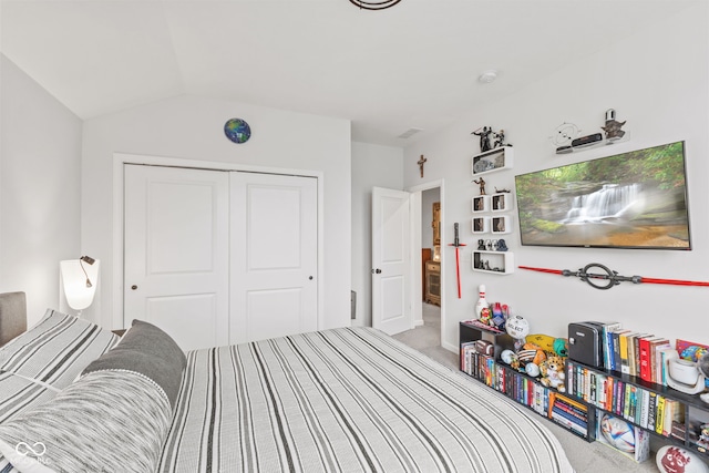 bedroom featuring carpet flooring, a closet, and vaulted ceiling