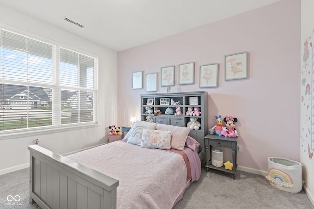 carpeted bedroom with multiple windows