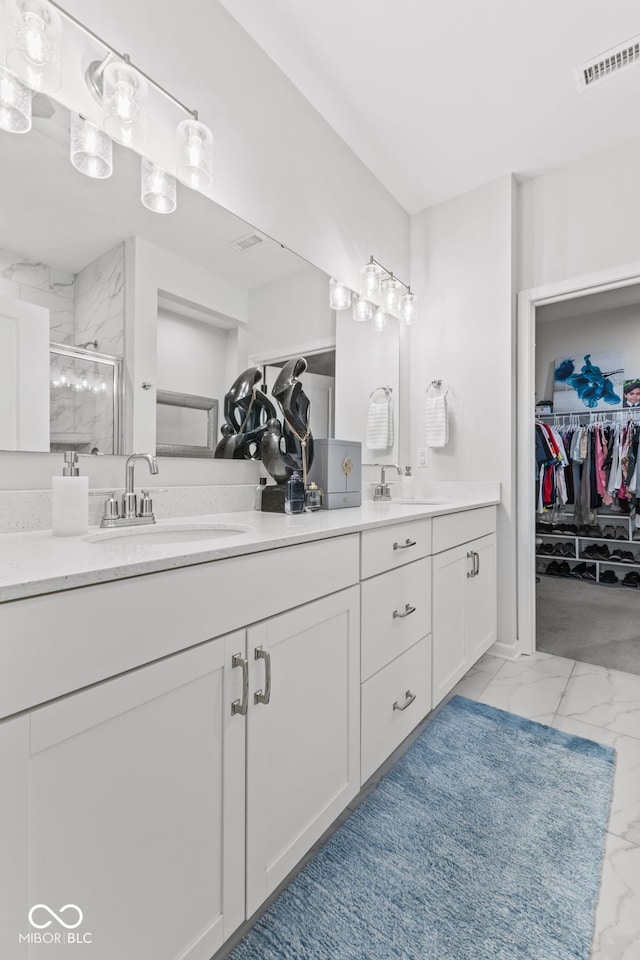 bathroom featuring vanity and a shower with shower door