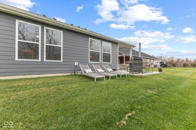 back of house with a patio area and a yard