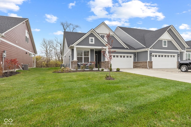 craftsman-style home with central AC unit, a front lawn, and a garage