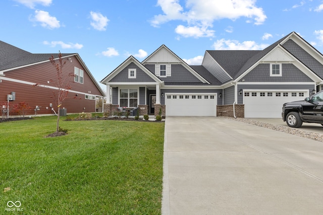 craftsman house with a garage, central air condition unit, and a front yard