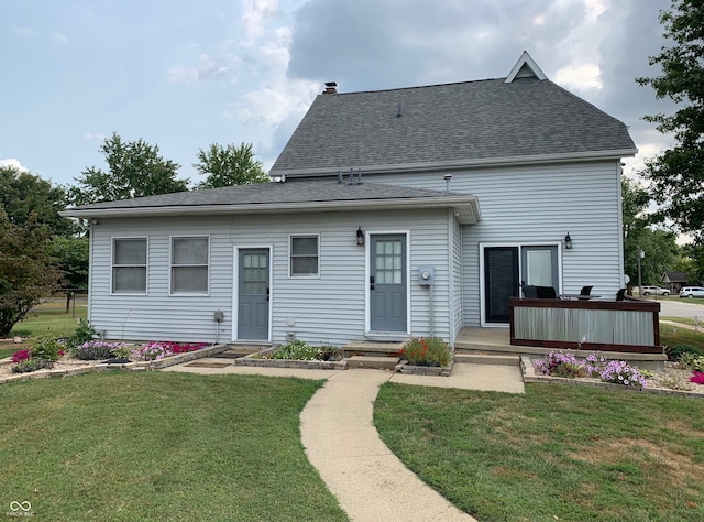 rear view of property with a lawn