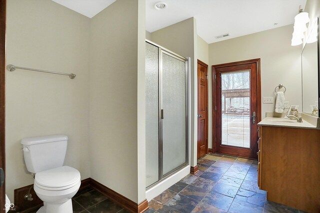 bathroom with vanity, toilet, and an enclosed shower