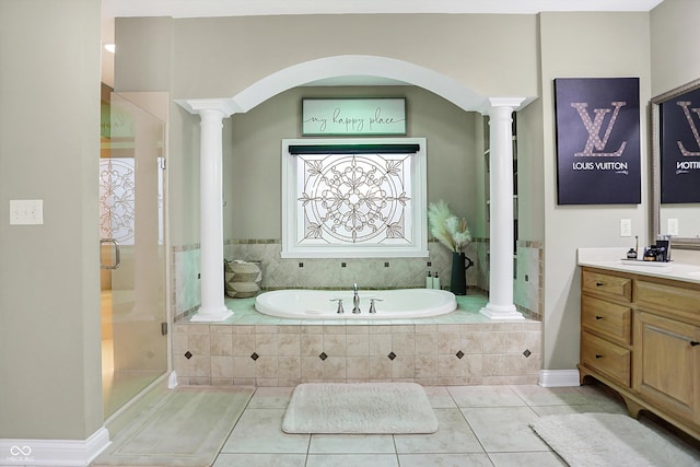 bathroom featuring plus walk in shower, vanity, and tile patterned floors