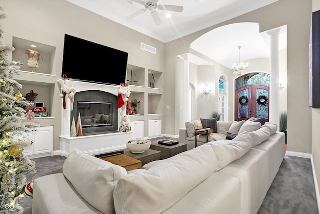 living room featuring french doors, built in features, and ceiling fan with notable chandelier