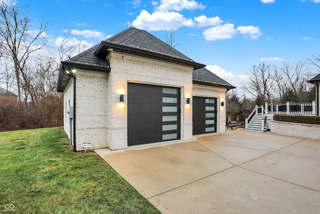 view of home's exterior with a lawn and a garage