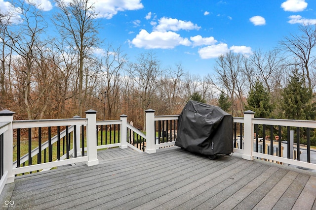 wooden deck with a grill