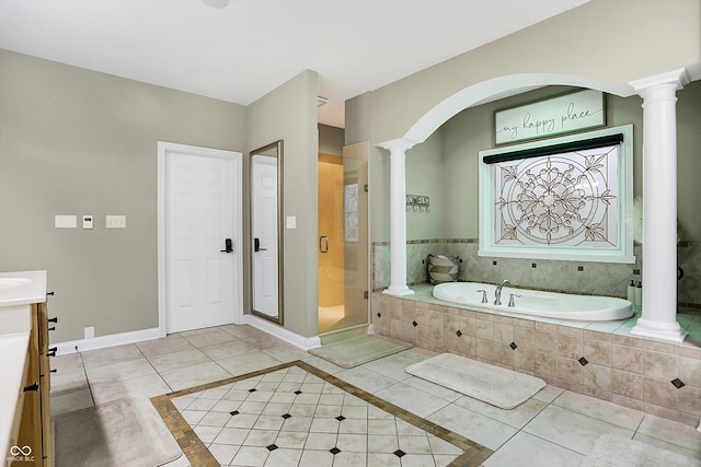 bathroom with tile patterned floors, vanity, and shower with separate bathtub