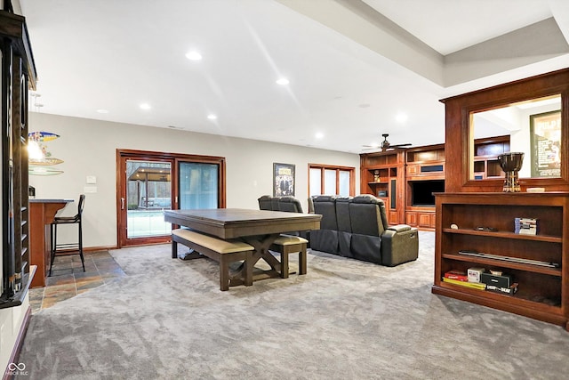 carpeted dining area featuring built in shelves, ceiling fan, and plenty of natural light