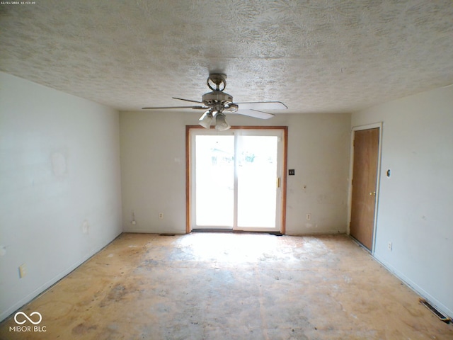 spare room featuring ceiling fan and a textured ceiling