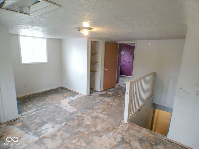 basement featuring a textured ceiling