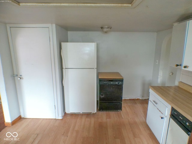 kitchen with light hardwood / wood-style floors, white cabinetry, and white appliances