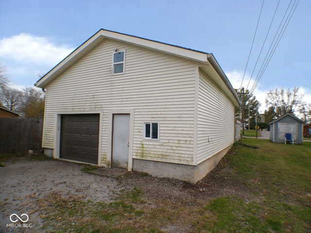 view of home's exterior with a garage and a storage shed