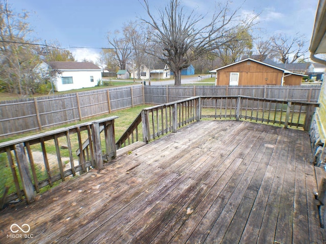 wooden terrace with a lawn