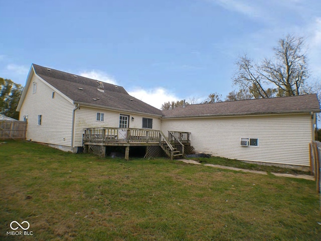 back of house featuring a lawn and a wooden deck