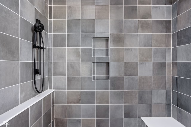 bathroom with a tile shower