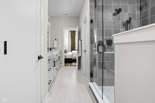 bathroom featuring vanity and a shower with door