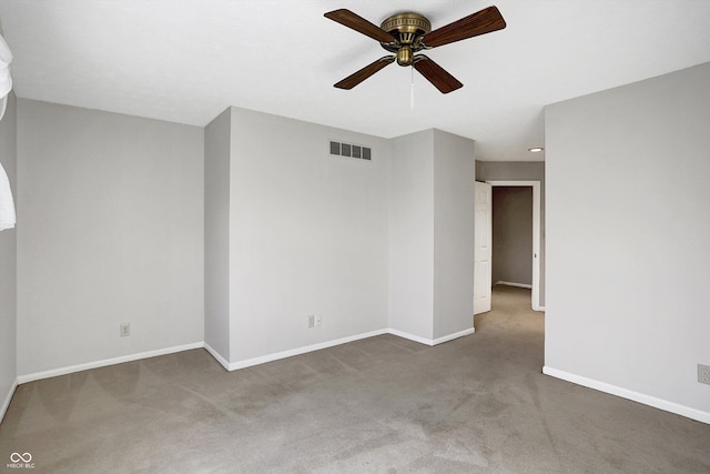 spare room featuring ceiling fan and carpet