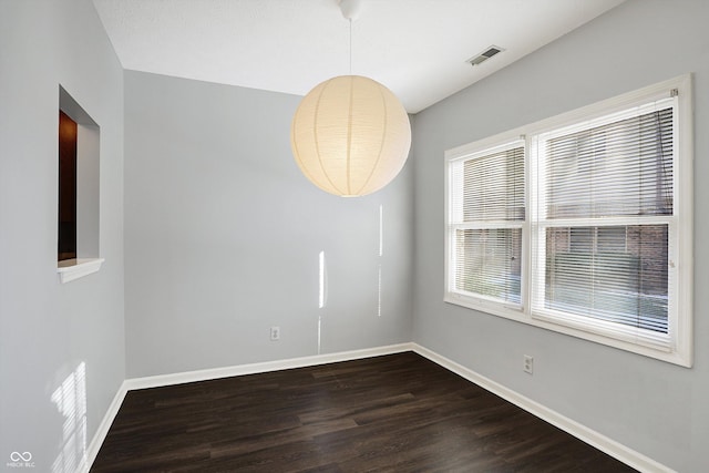 spare room featuring dark hardwood / wood-style floors