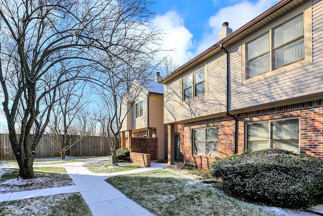 view of property exterior with a yard