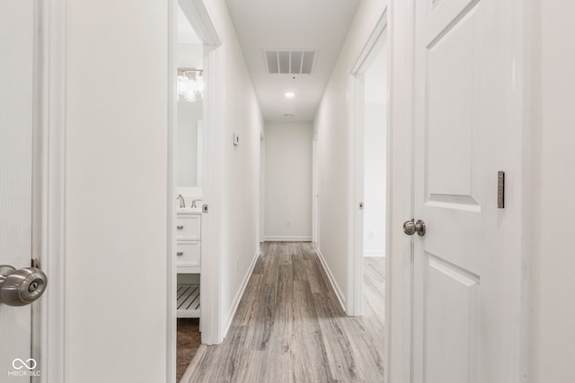 hallway with hardwood / wood-style floors