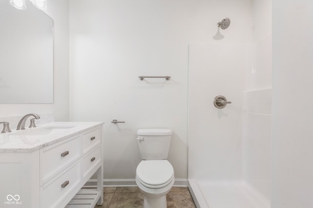 bathroom with tile patterned flooring, toilet, vanity, and walk in shower