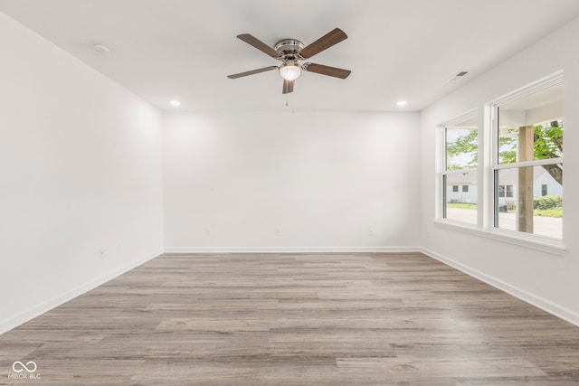 empty room with light hardwood / wood-style floors and ceiling fan