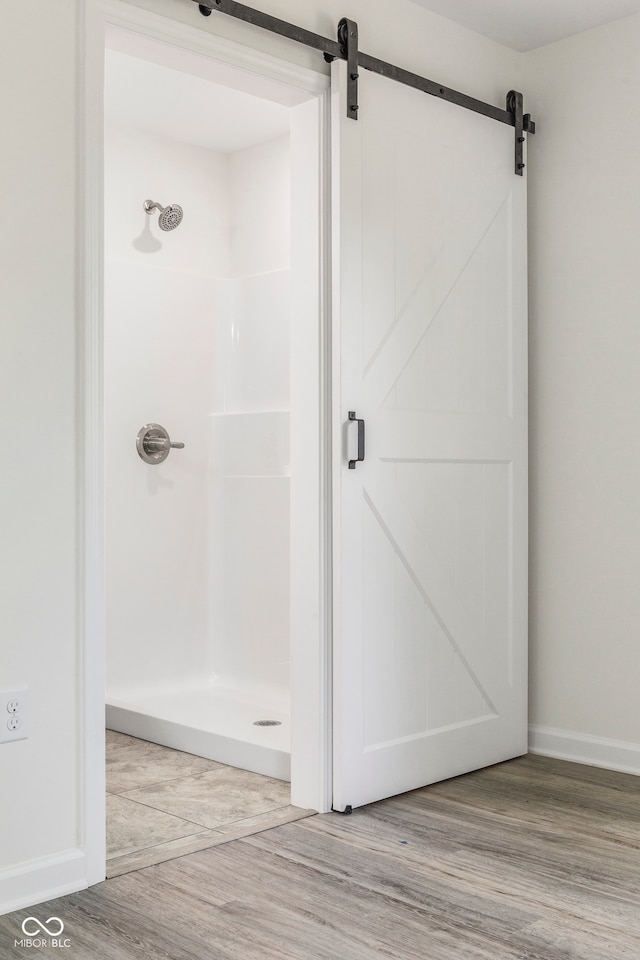 bathroom featuring walk in shower and wood-type flooring