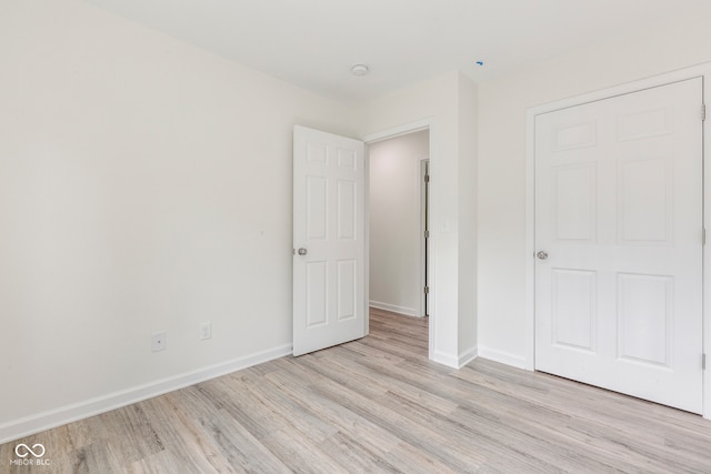 unfurnished bedroom featuring light wood-type flooring